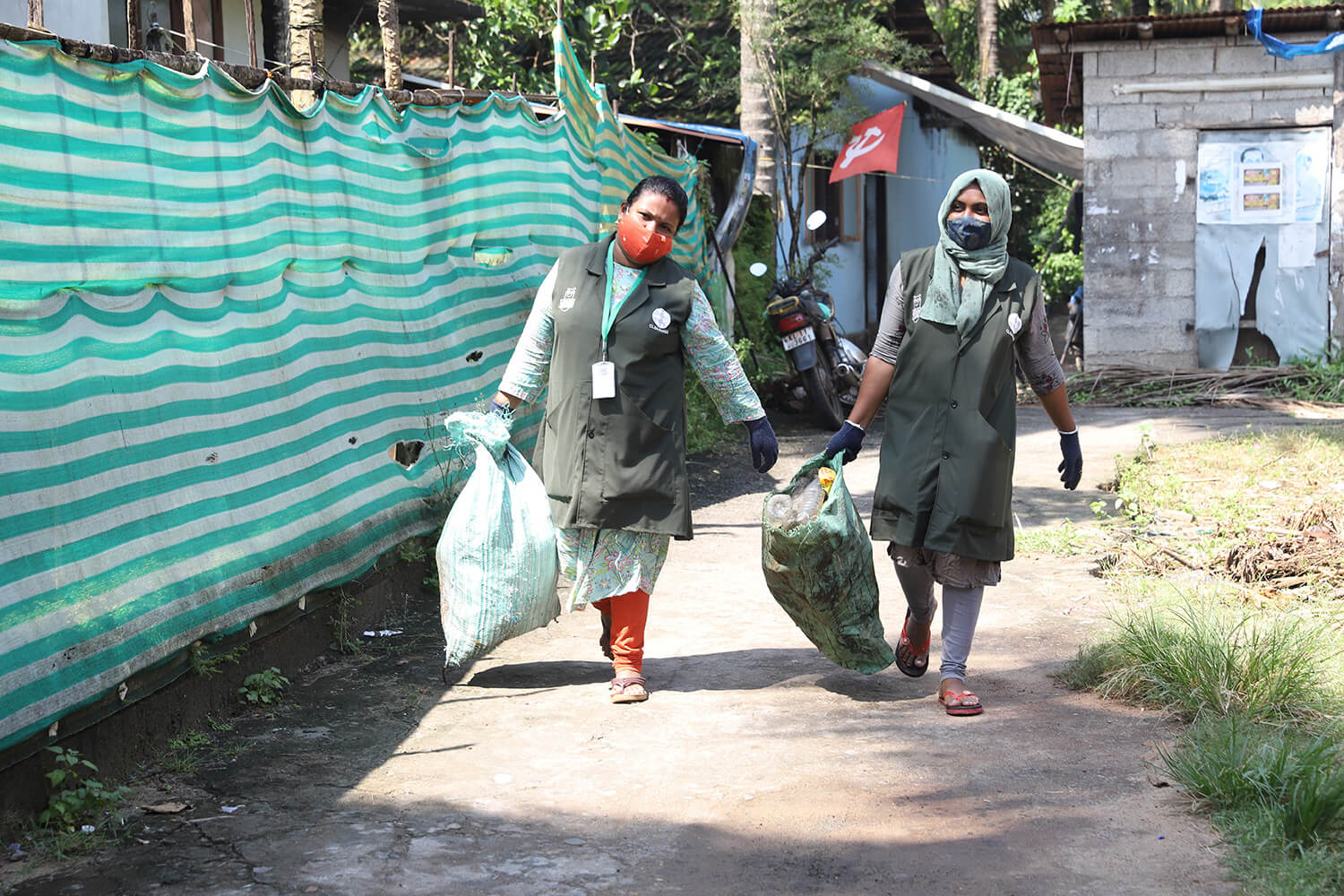 Women-carrying-waste-bags-1